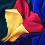 Photo by Prince Abid photo of red, yellow, blue and green silk cloths